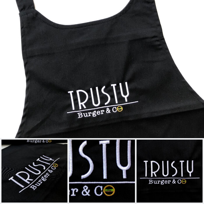 Tabliers brodés de couleur noir avec le logo du restaurant Trusty Bruger